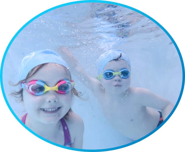 two children swimming underwater in the pool